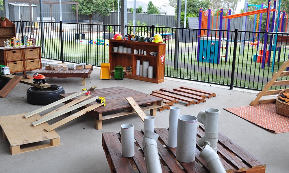 pallets used as toys in outdoor play area at Aberglasslyn