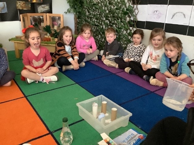 An explosion of colour at Telford Park children sitting cross legged on colourful flooring