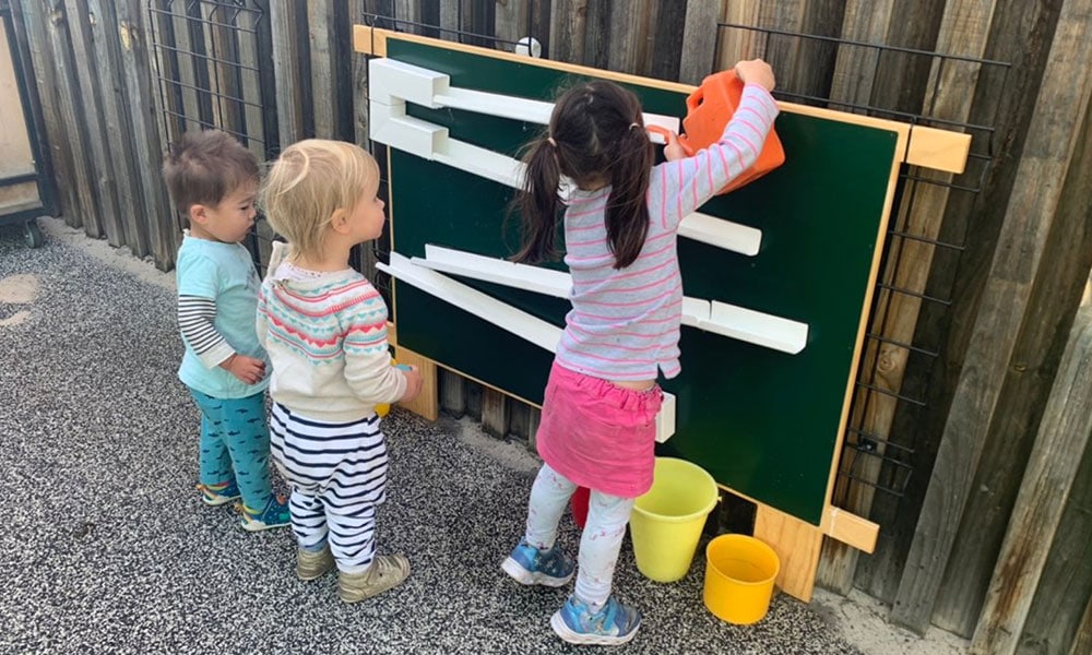 Children playing with watering cans