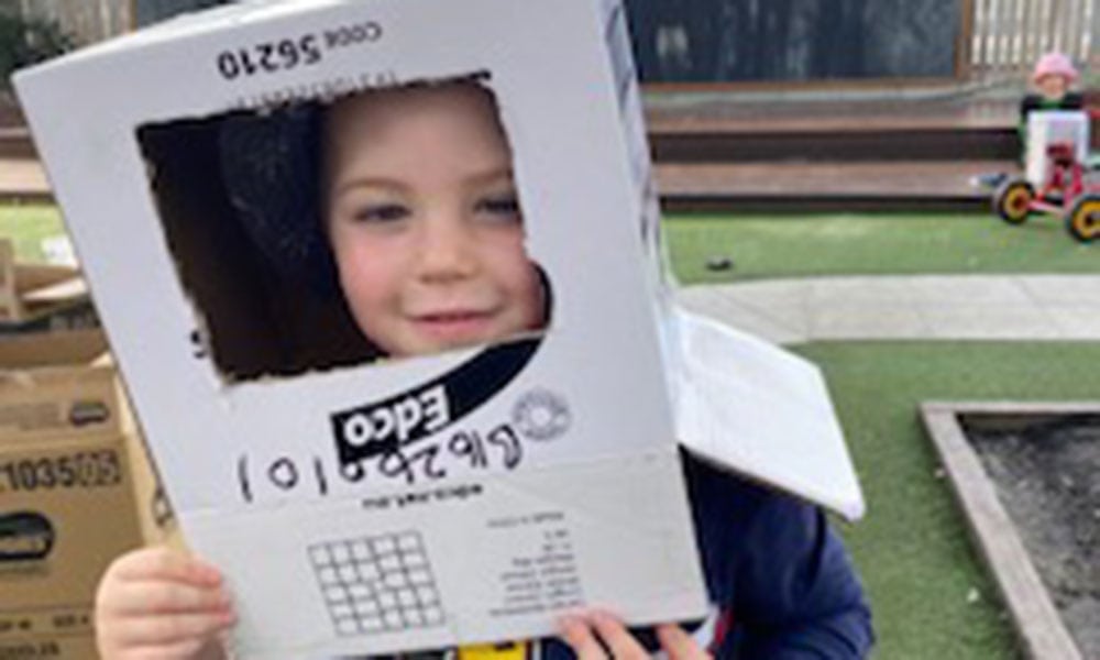 A child playing with boxes