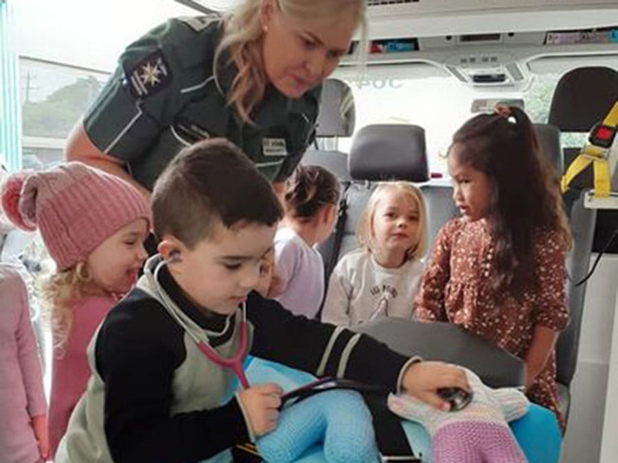 Children receiving first aid training in an ambulance at Story House Lara