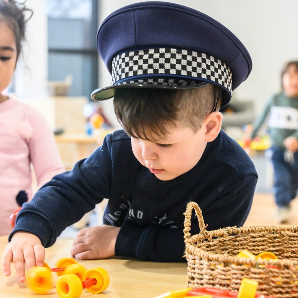 child wearing a policeman hat