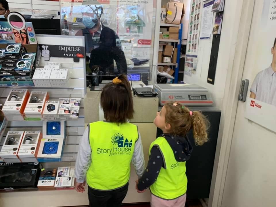 Children holding hands visiting the post office