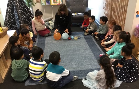 A group of children being taught about earthquakes and tsunamis at Story House Mascot