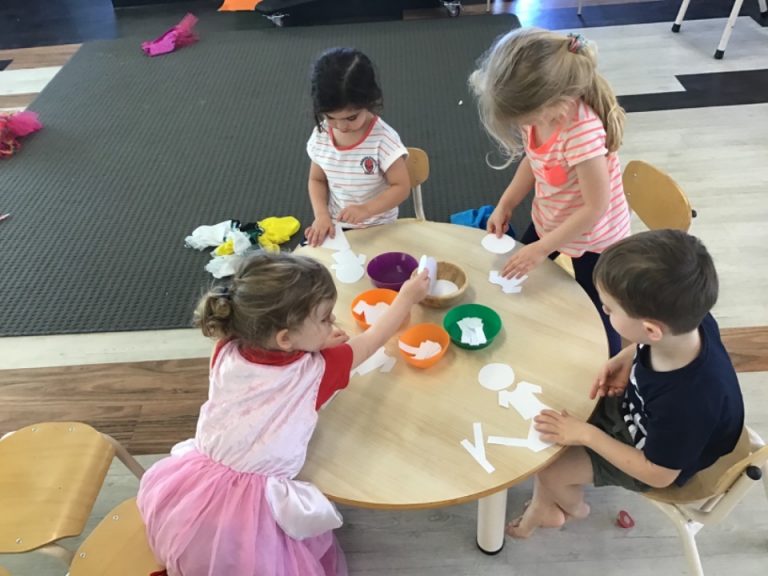 Children playing together round a table